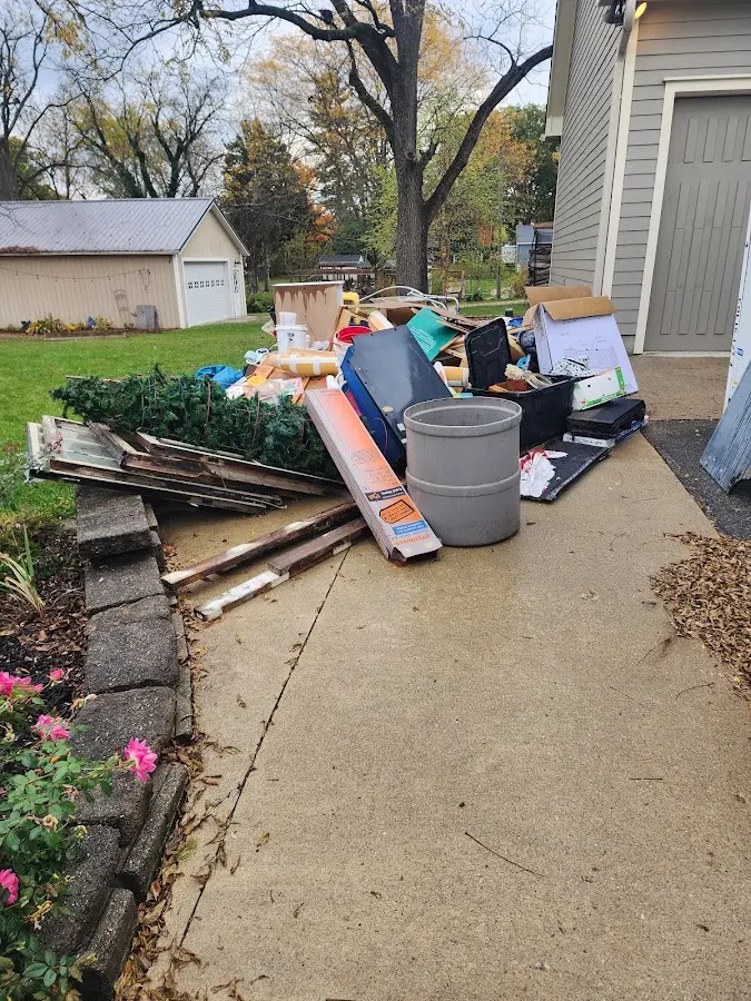Dumpster being loaded with debris for Estate Cleanout Dumpster Rental in Fremont